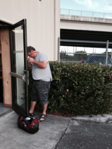 Technician fixing a lock in a commercial building